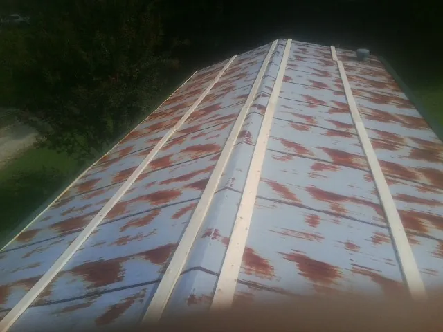 Rusted metal roof panels with new wood purlins before replacement — Storm Damage Roof Repair in Pennsauken by Roofing Brothers